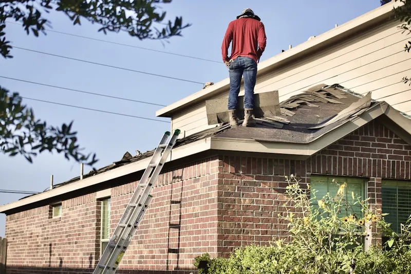 Professional roofer working on a residential roof in Morehead City